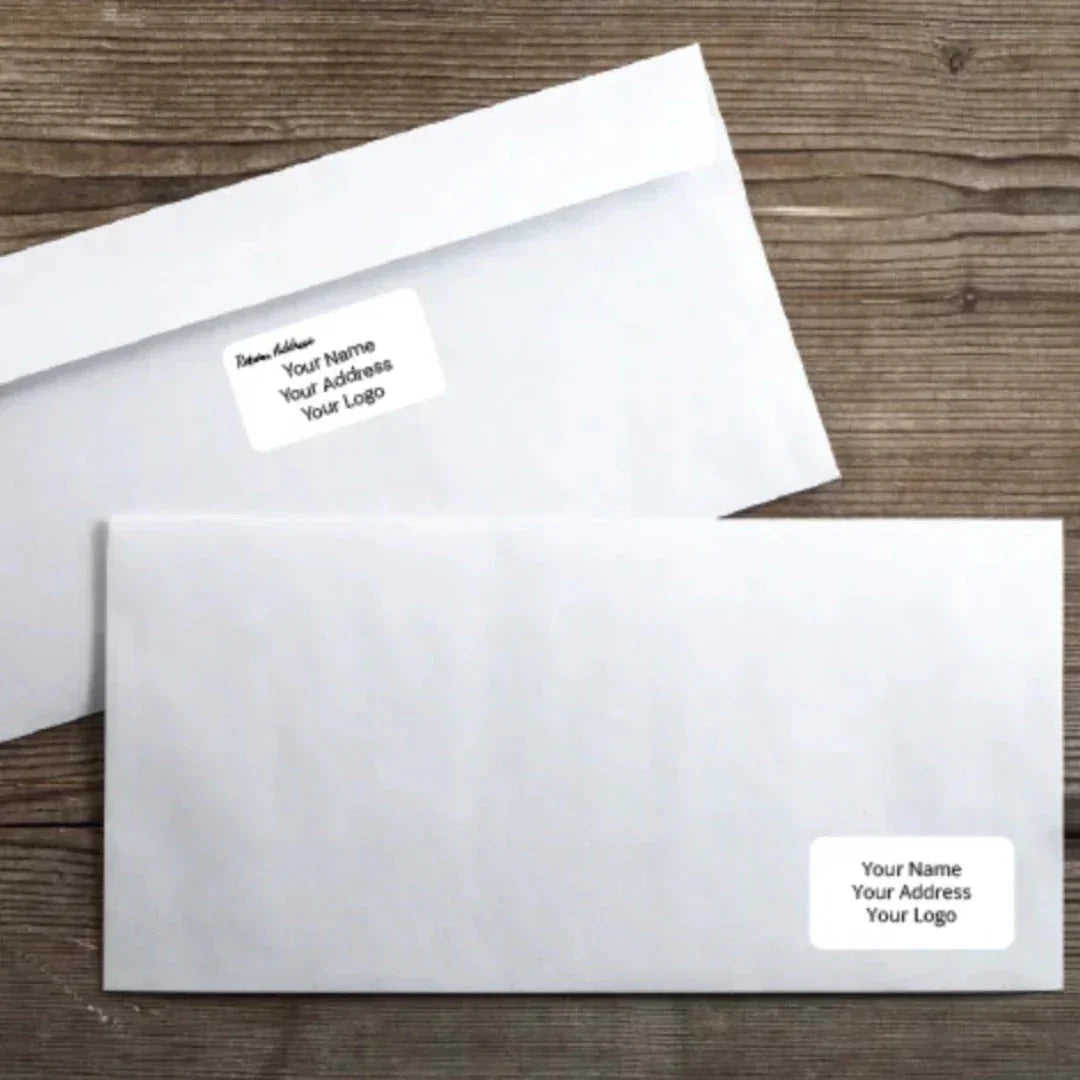 White envelopes with custom return address labels on wooden surface